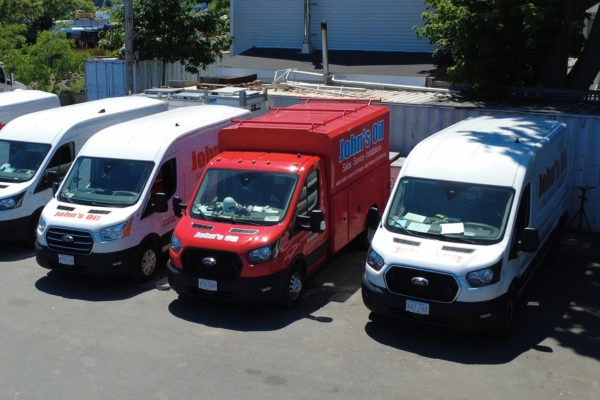 Jphn's Oil & Propane HVAC services vans parked in a row