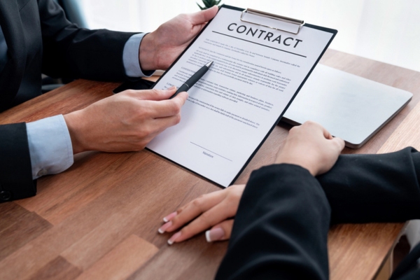 man explaining contract inclusions to a woman before signing