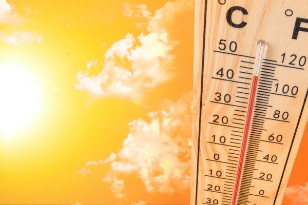 sunny skies and thermometer depicting summer heat